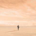 Silhouette of Man Walking On Empty Plain