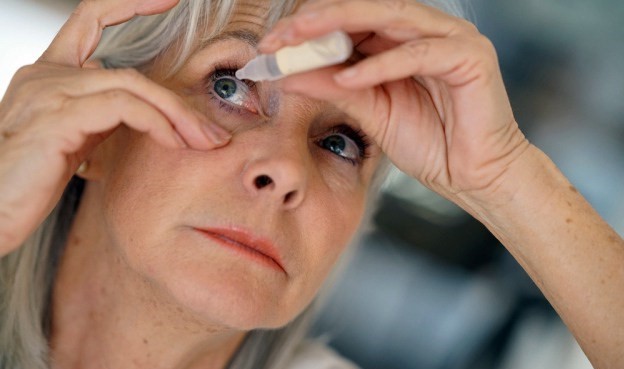 Woman Putting Eyedrops in Eye