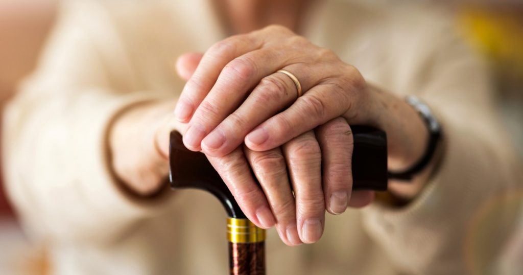 Wrinkled Hands of Senior Woman Parkinson’s Disease